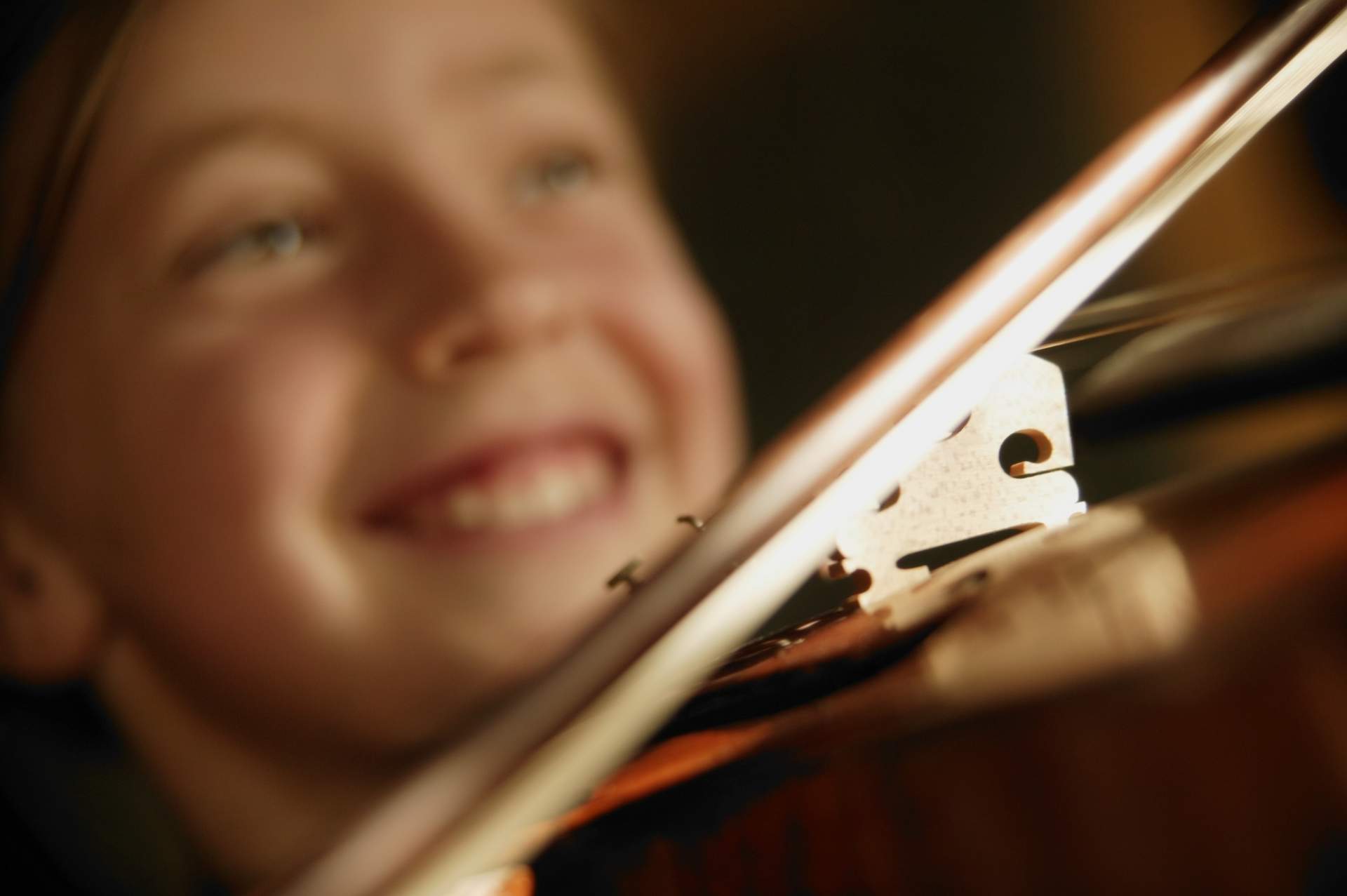 Young lady smiling playing the violin