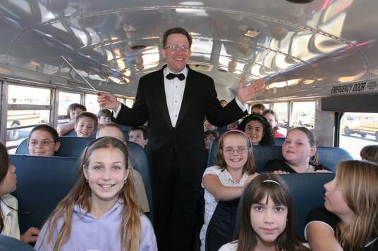 Conductor standing up in the bus