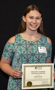 Raegan O'Rourke smiling holding her scholarship