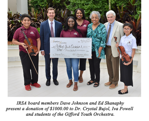 IRSA board members Dave Johnson and Ed Shanaphy present a donation of $1000.00 to Dr. Crystal Bujol, Iva Powell and students of the Gifford Youth Orchestra.