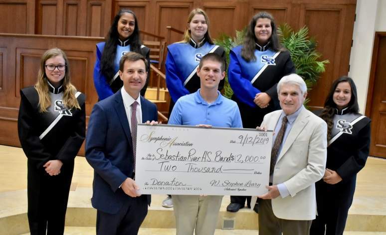 IRSA board members Dave Johnson and Ed Shanaphy present a donation of $2,000.00 to Chase Jones of Sebastian River High School.